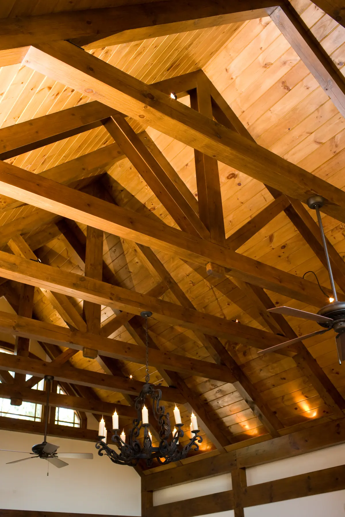 An intricate pitched interior roof, showing detailed timber framing